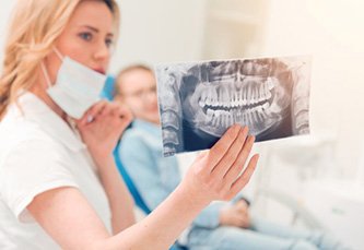 Dental patient views X-rays of teeth
