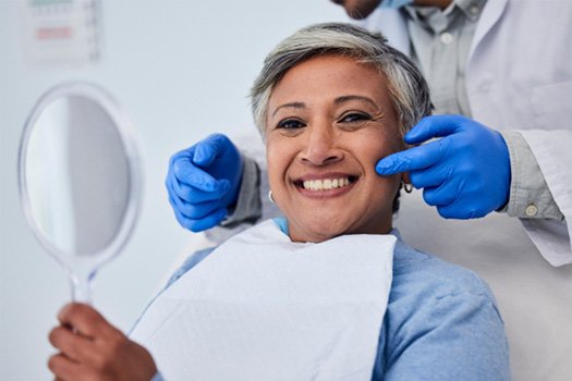 Patient smiling after getting dentures