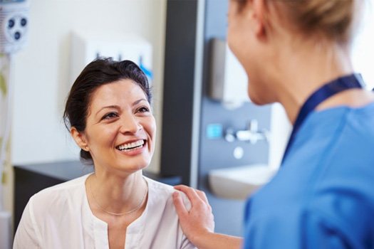 Patient smiling after being reassured by dental specialist