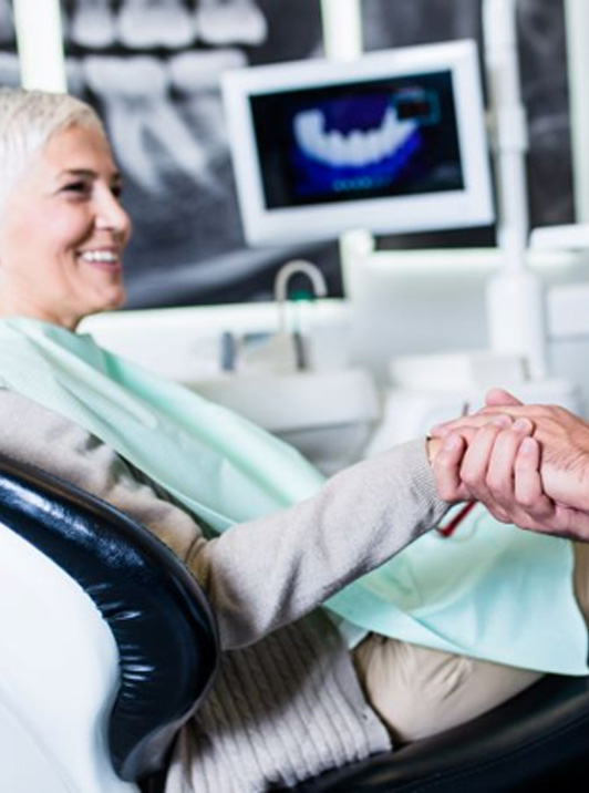 Dental patient shaking hands with dentist