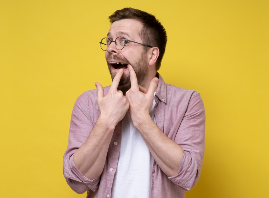 Man pointing to missing tooth