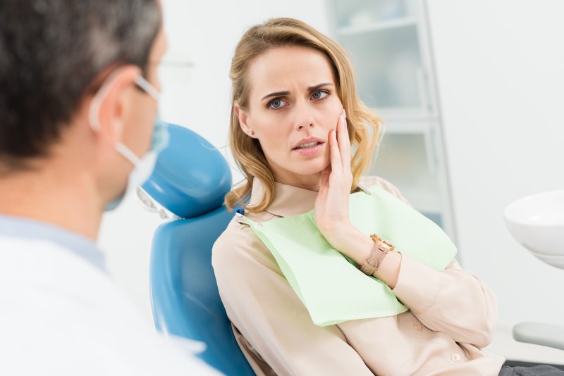 Patient talking to dentist about sensitive dental implant