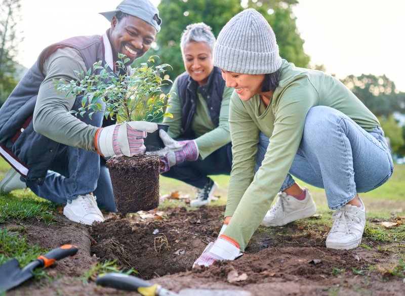 Patient with sleep apnea smiling while gardening with friends
