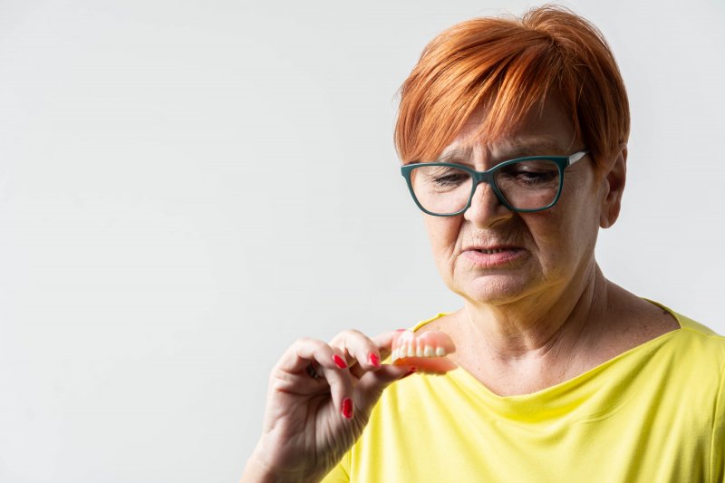 Patient looking dubiously at their dentures