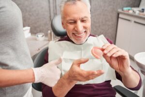 Man getting his dentures relined