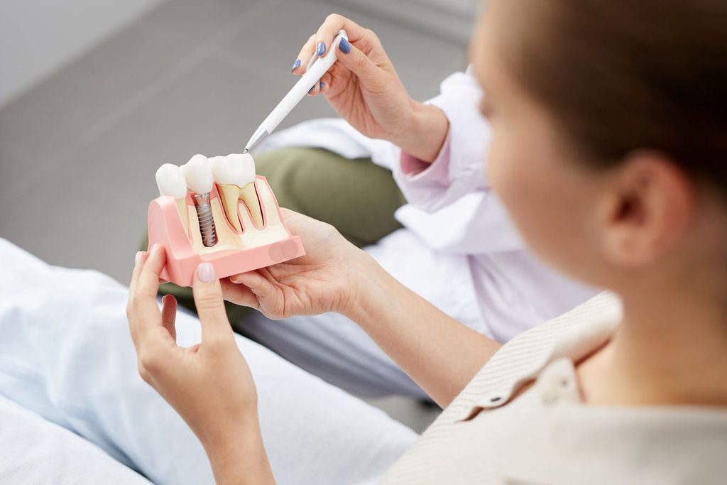 A dentist discussing dental implants with a patient